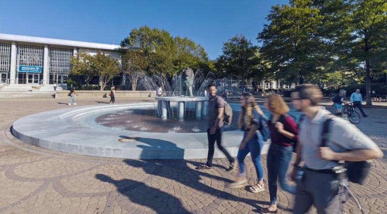 Students walking by Monarch fountain